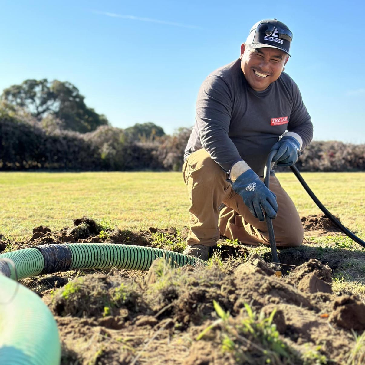 Worker pumping a septic tank